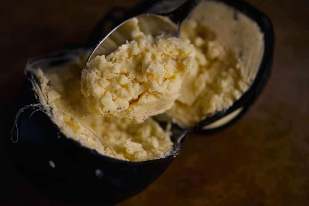 Scoop of cheese on a wooden surface