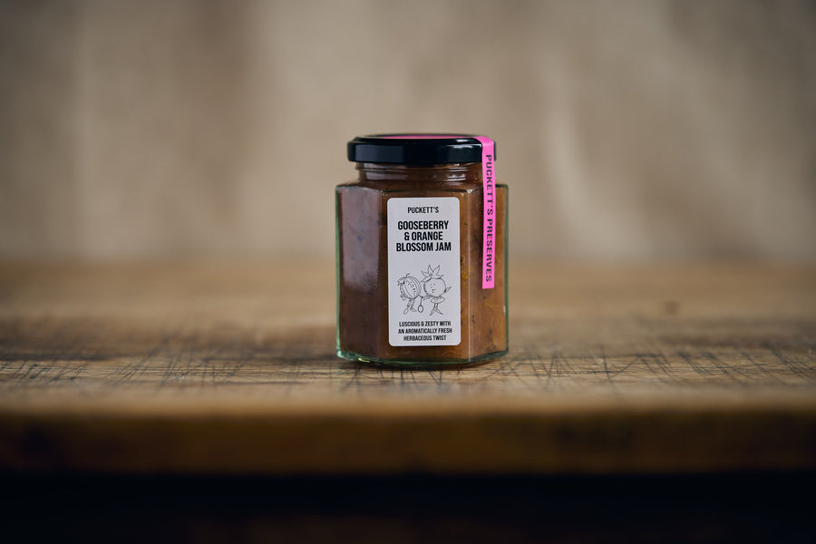 Jar of jam with a label on a wooden surface