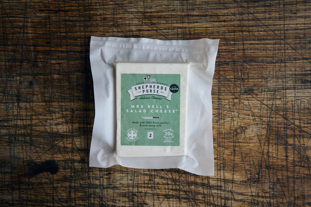 Packaged salad cheese on a wooden surface