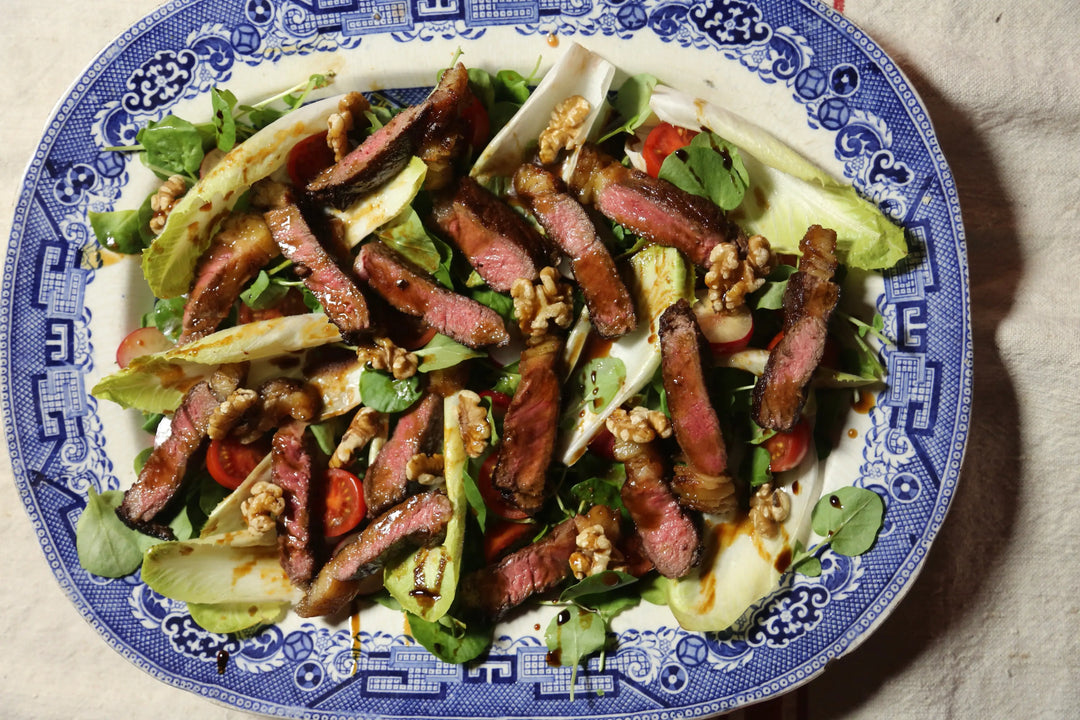 Sirloin steak salad of chicory, watercress and radish with a date vinaigrette