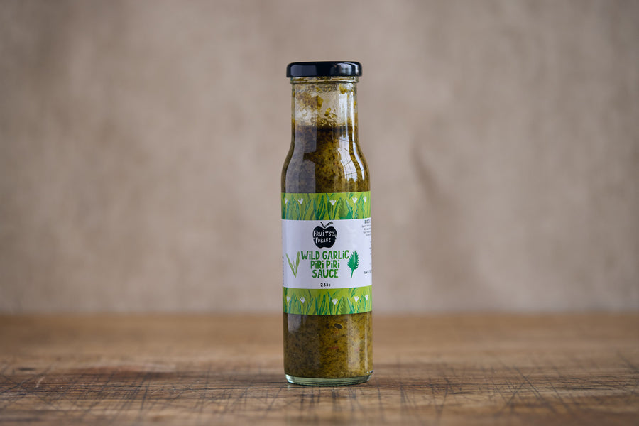 Bottle of Wild Garlic Herb Sauce on a wooden surface with a brown background